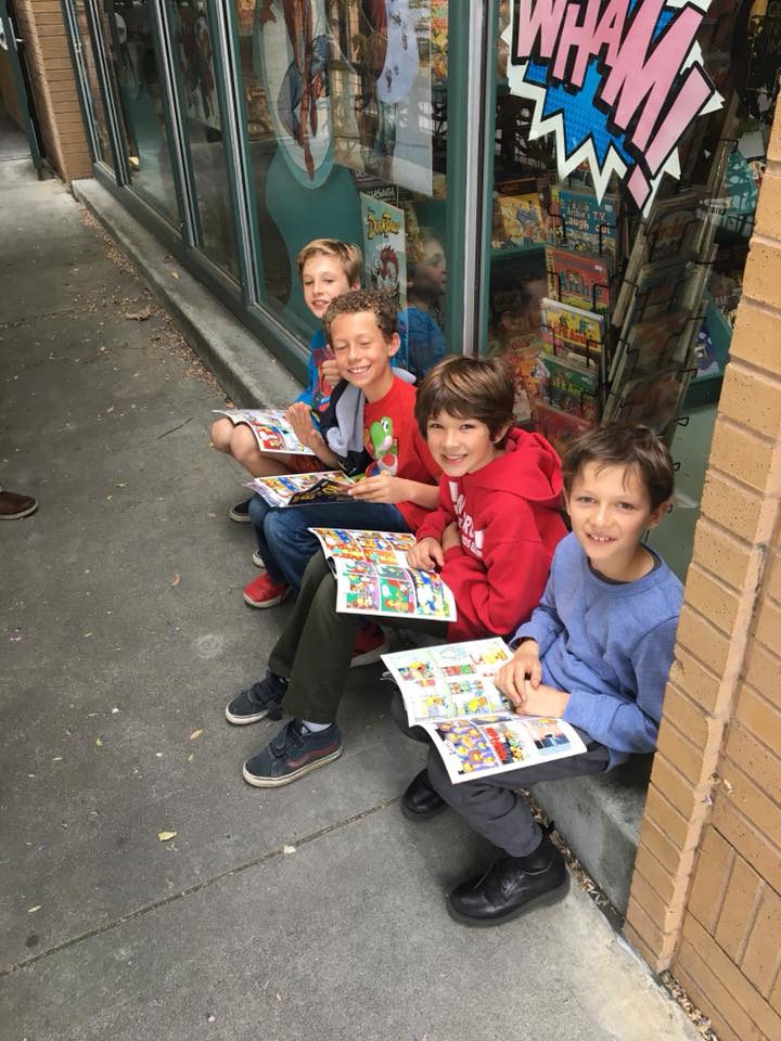 Kids reading on the sidewalk